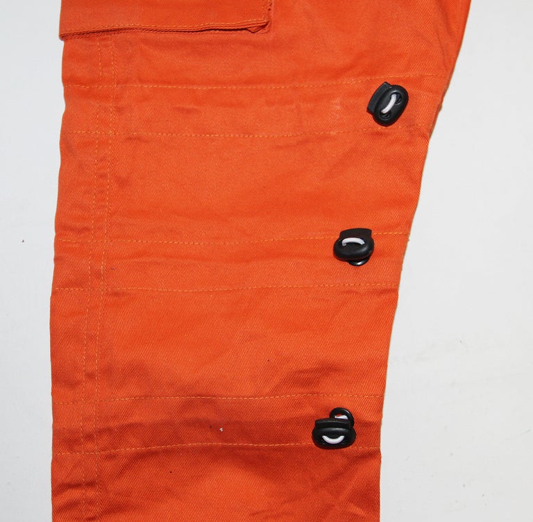 Orange cargo pants bungee cord detail