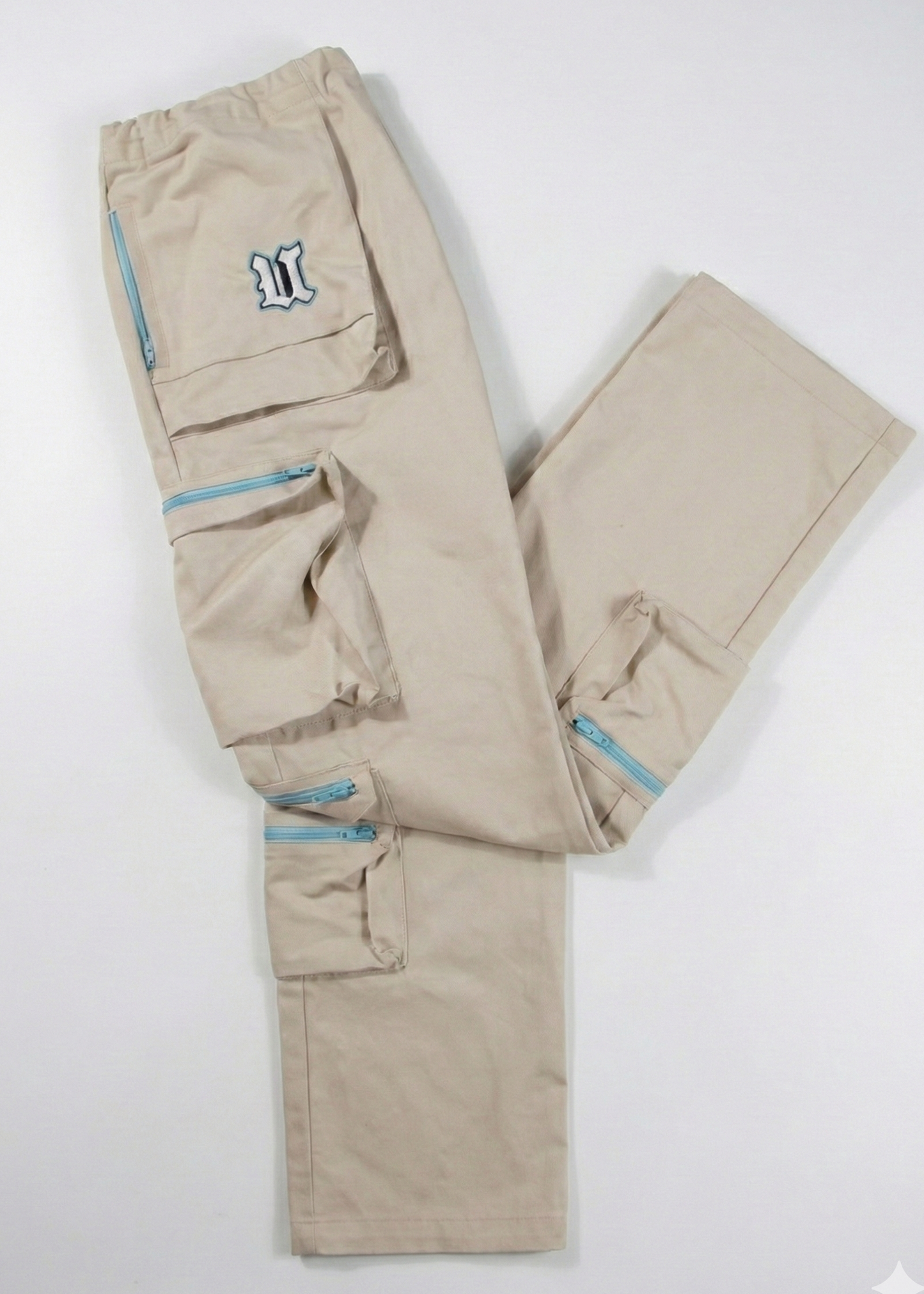 Beige cargo pants with blue zippers on a white background