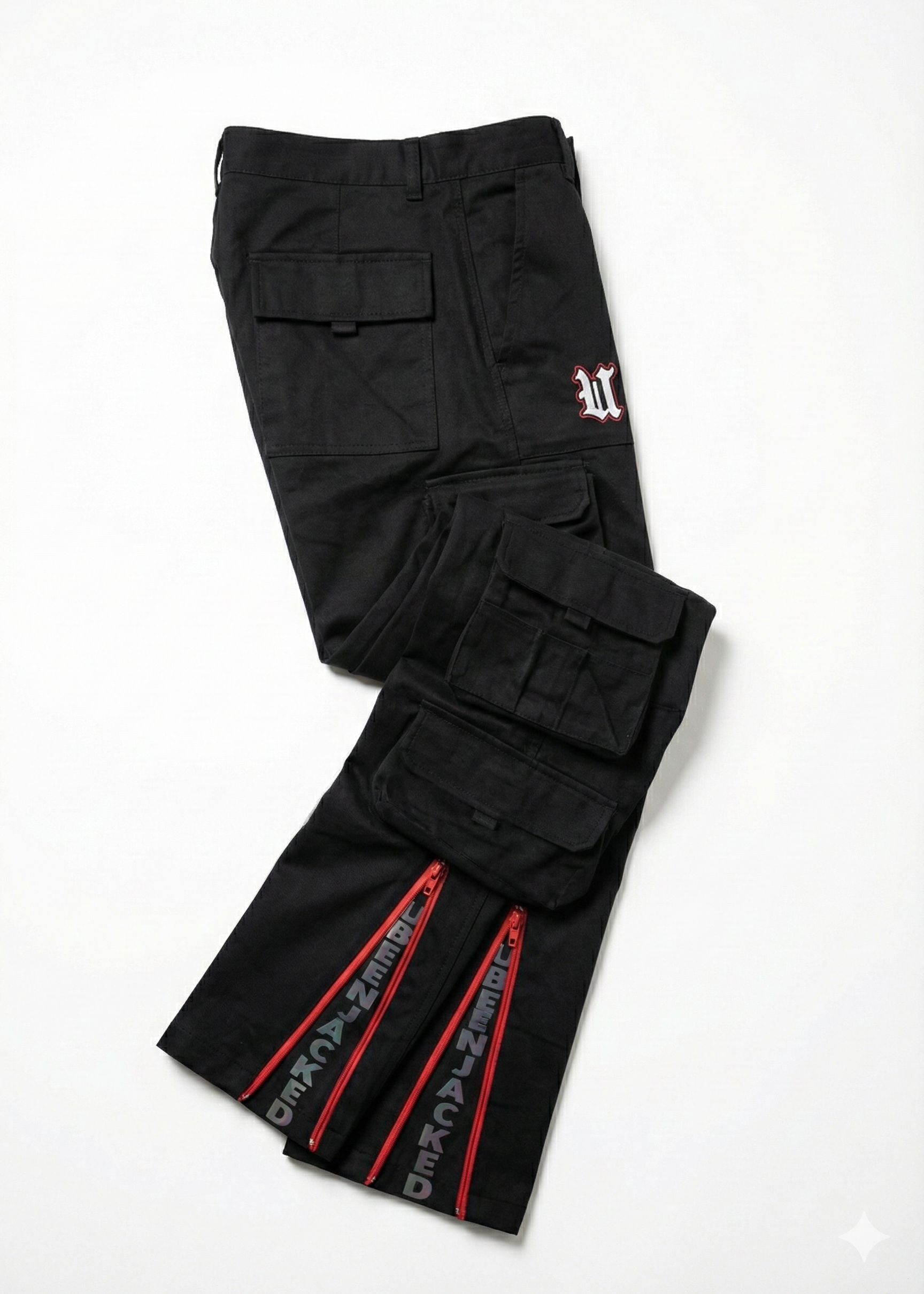 Black cargo pants with red zippers on a white background