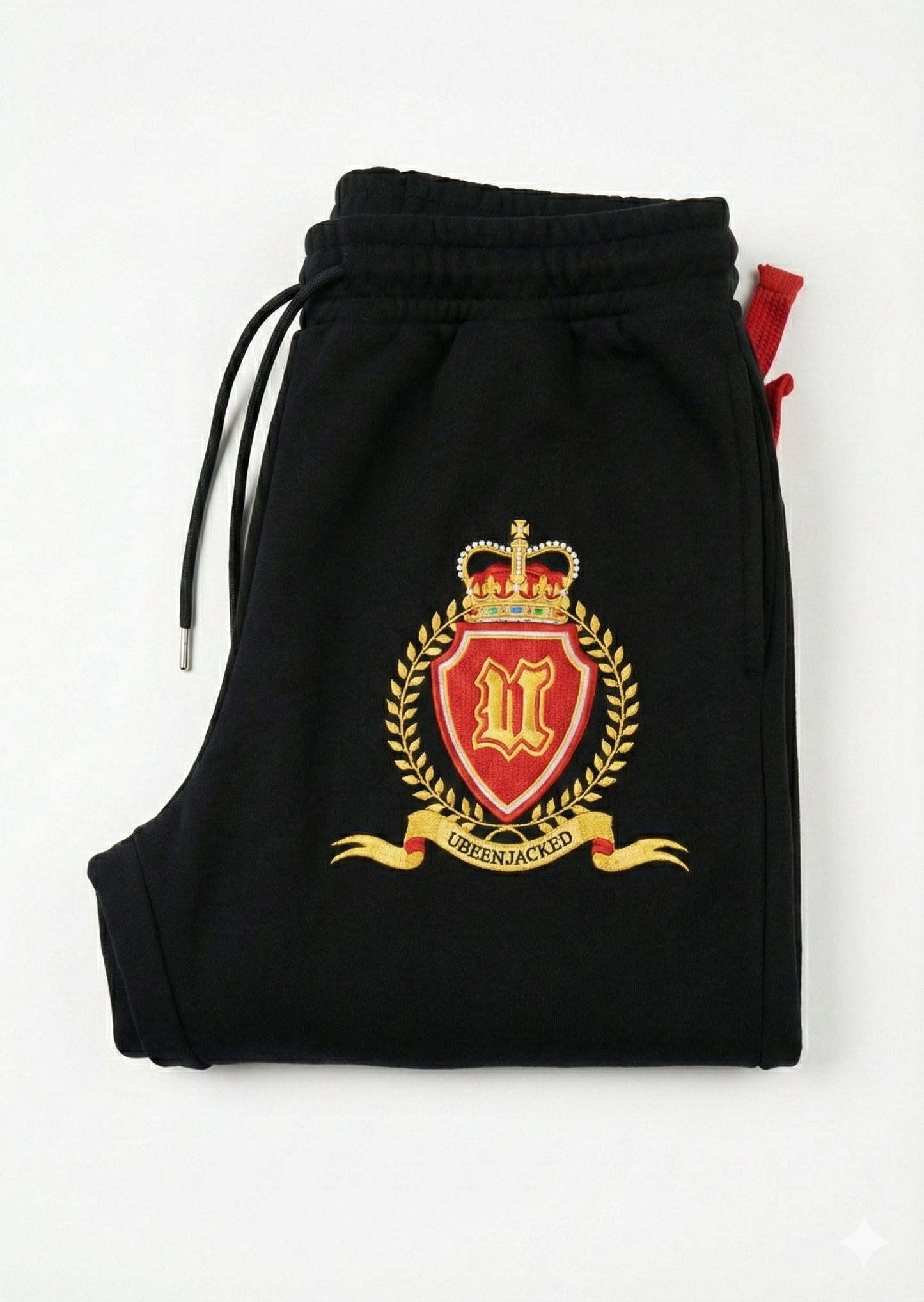 Black tracksuit with a red and gold emblem on a white background