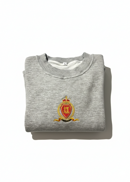 Folded gray sweatshirt with a crest on a white background