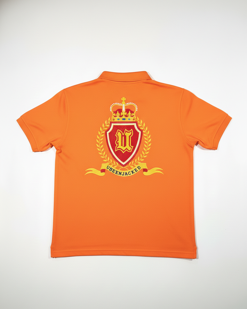 Orange polo shirt with a crest design on the back against a white background