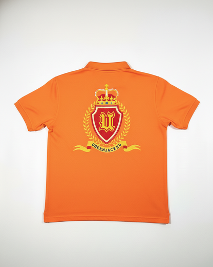 Orange polo shirt with a crest design on the back against a white background