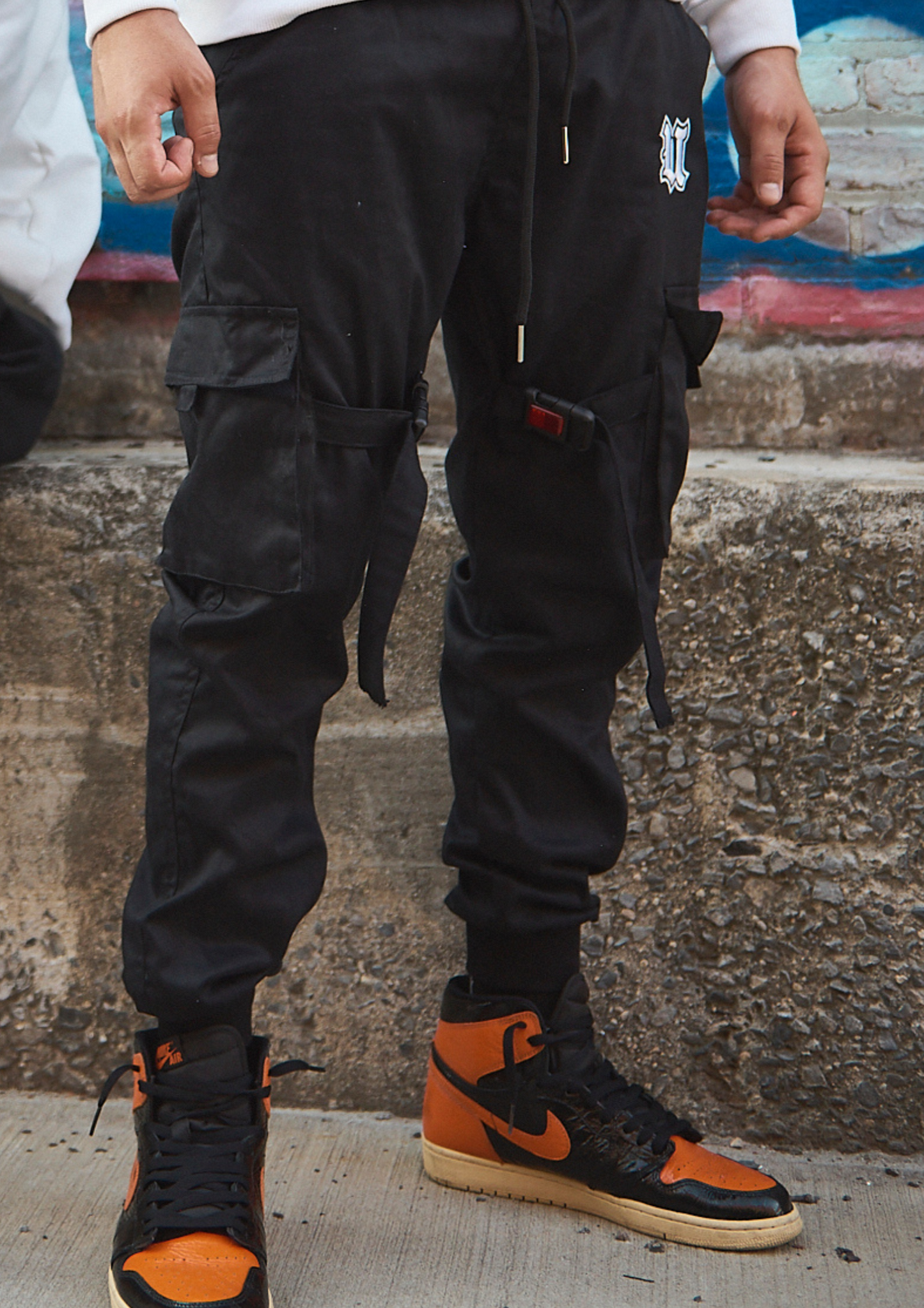 Front View Black Cargo Pants with Reflective Buckles Lifestyle shot