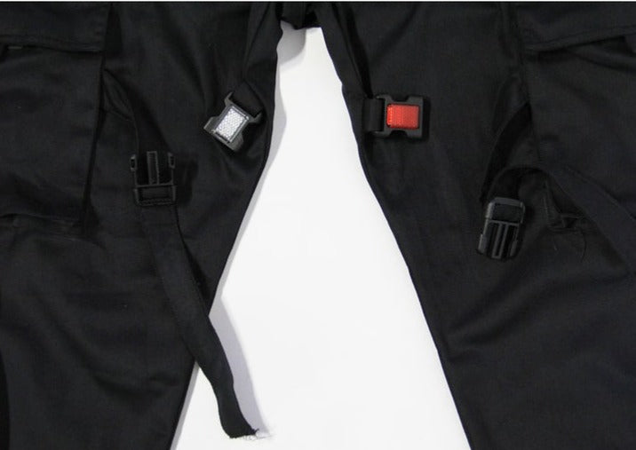 Close up reflective buckles on black cargo pants